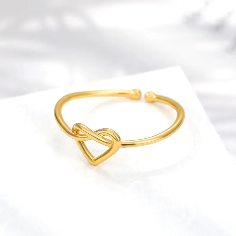 “Gold color stainless steel couple rings, heart design, luxury wedding jewelry.”