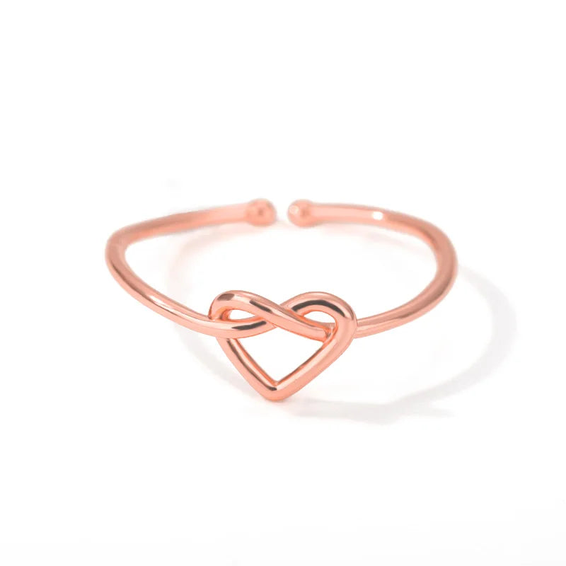 “Gold color stainless steel couple rings, heart design, luxury wedding jewelry.”