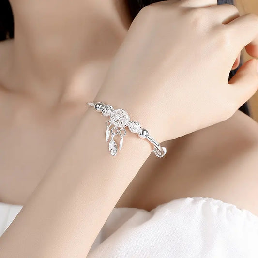 “Silver-Plated Dreamcatcher Bracelet: Elegant Leaves, Tassels, and Beads for Timeless Style.”