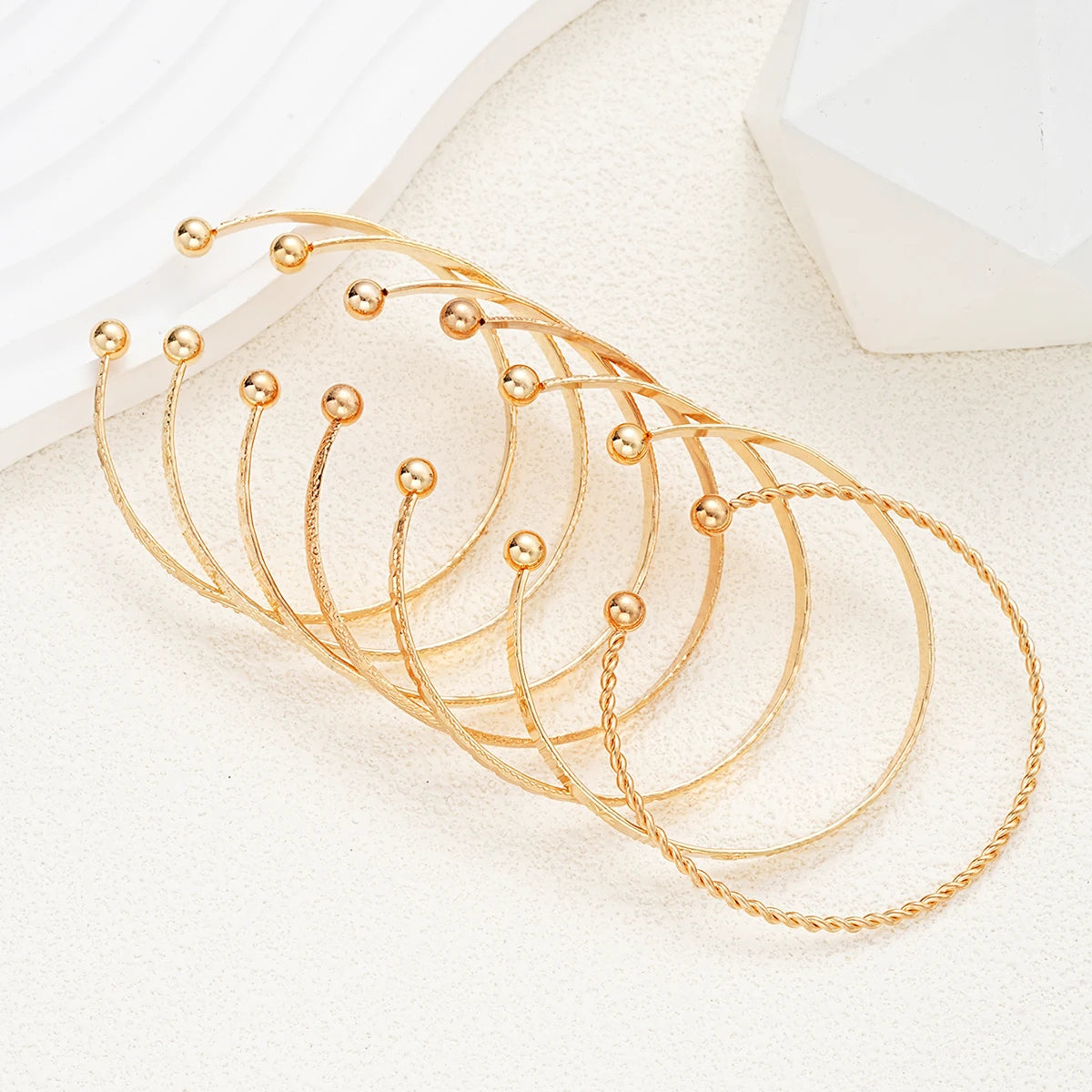 “7-piece gold bracelets set: punk heart designs, open bangles, trendy streetwear.”