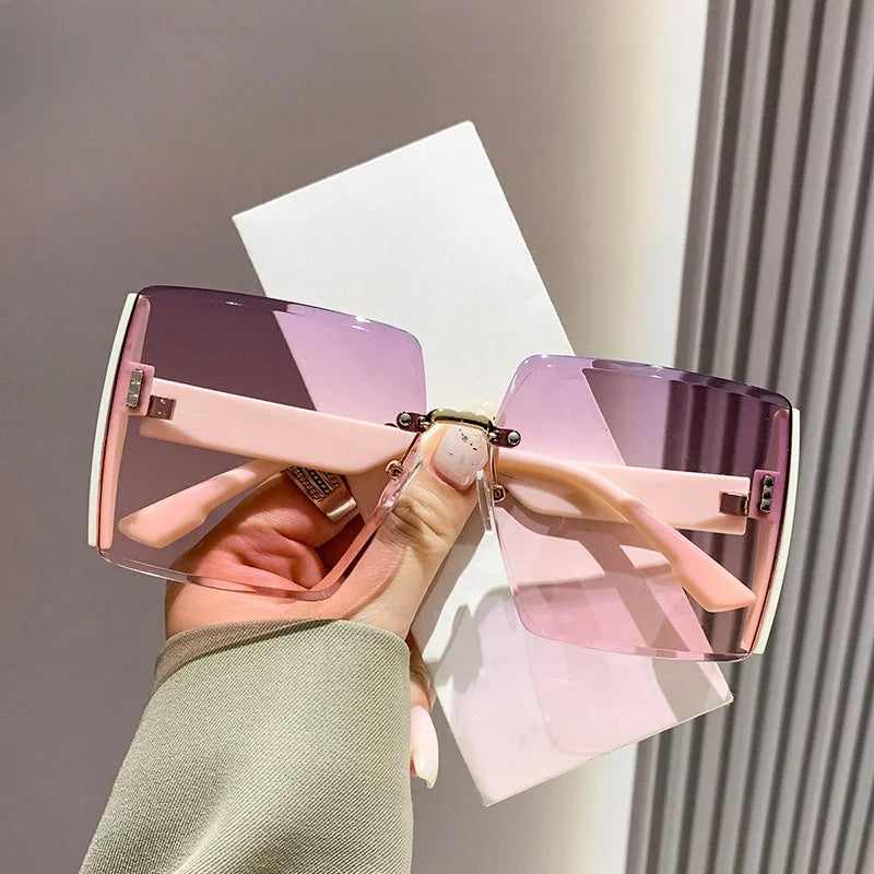“Fashion rimless women’s sunglasses, gradient lenses, retro UV400 beach style.”
