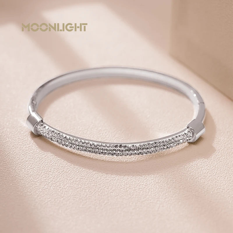 “Trendy titanium steel cuff bracelet with cubic zirconia, classic circular design.”