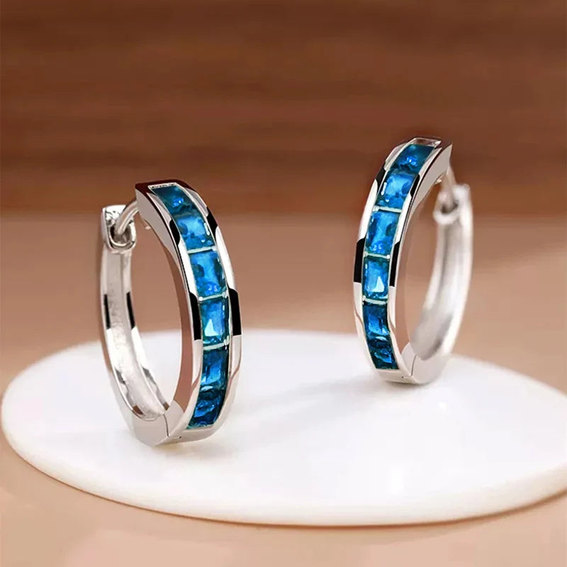 “Classic hoop earrings with princess-cut CZ, elegant and versatile women’s accessories.”
