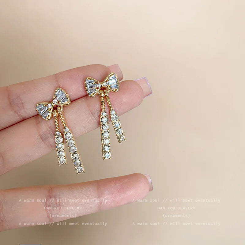 “Gold Bow Stud Earrings for Women - Dainty Rhinestone Jewelry.”