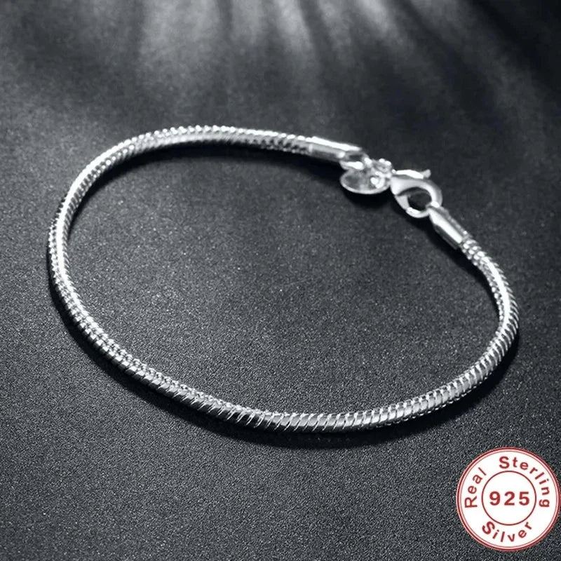 “Luxury Handmade 925 Sterling Silver Charm Bracelet - Smooth Snake Bone Design.”