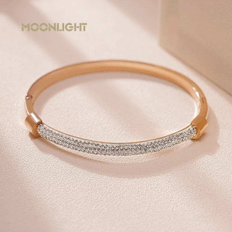 “Trendy titanium steel cuff bracelet with cubic zirconia, classic circular design.”