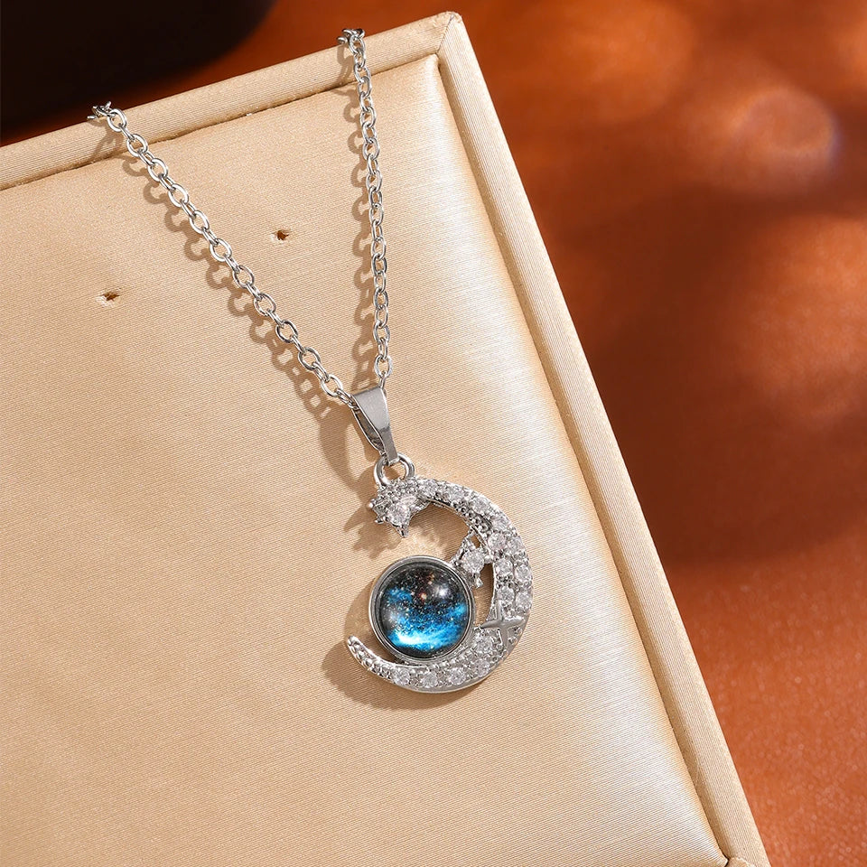 “Luxury gold titanium steel necklace with planet, moon, astronaut pendants.”
