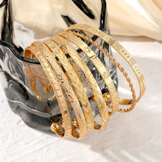 “7-piece gold bracelets set: punk heart designs, open bangles, trendy streetwear.” - Dazzory