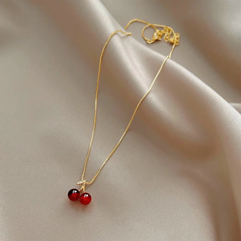 “Stainless Steel Wine Red Cherry Pendant Necklace - Gold Color, Fashion Jewelry for Women.”