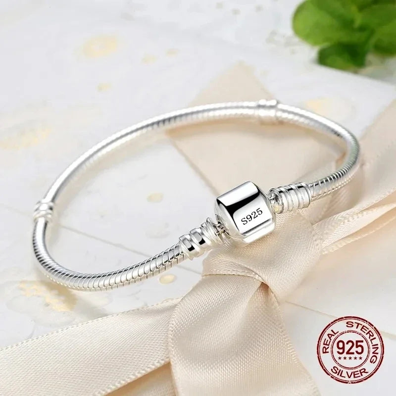 “Luxury Handmade 925 Sterling Silver Charm Bracelet - Smooth Snake Bone Design.”