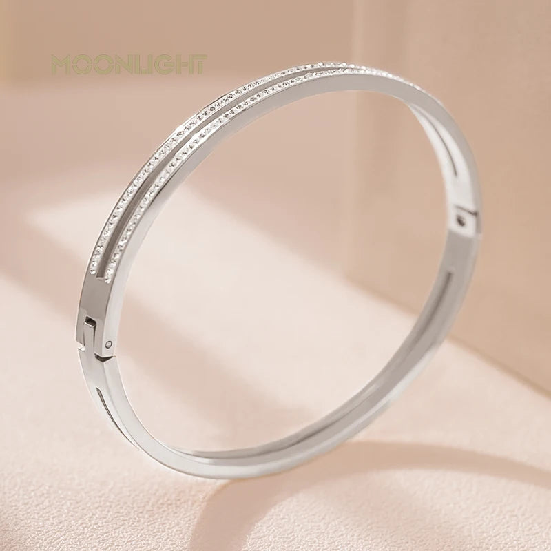 “Trendy titanium steel cuff bracelet with cubic zirconia, classic circular design.”