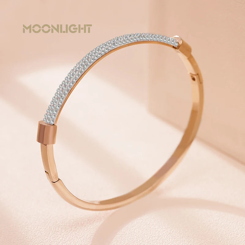 “Trendy titanium steel cuff bracelet with cubic zirconia, classic circular design.”