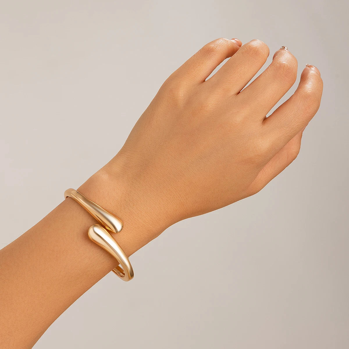 “Ingemark Creative Water Drop Metal Bangle - Gold Geometric Twisted Bracelet for Women.”