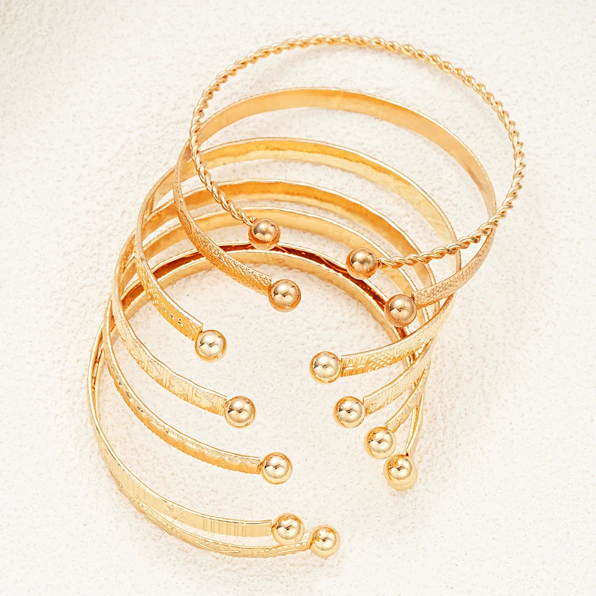 “7-piece gold bracelets set: punk heart designs, open bangles, trendy streetwear.”