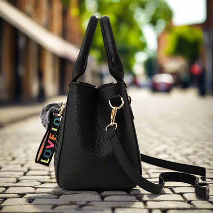 “Embroidered leather handbag for women with hairball detail, stylish and versatile.”