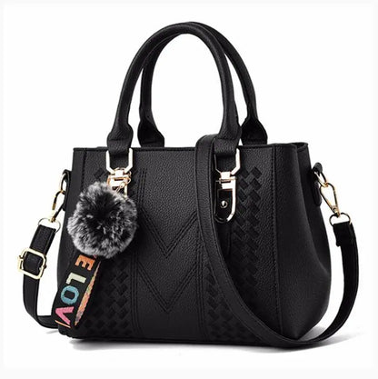 “Embroidered leather handbag for women with hairball detail, stylish and versatile.”