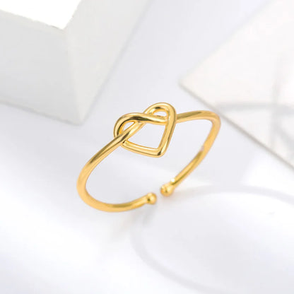 “Gold color stainless steel couple rings, heart design, luxury wedding jewelry.”