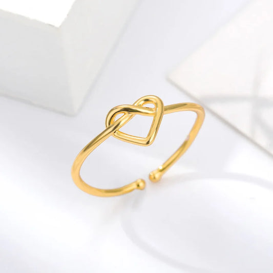 “Gold color stainless steel couple rings, heart design, luxury wedding jewelry.”