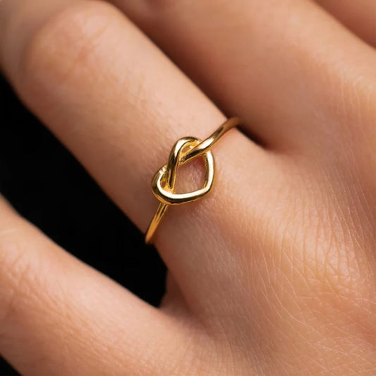 “Gold color stainless steel couple rings, heart design, luxury wedding jewelry.”