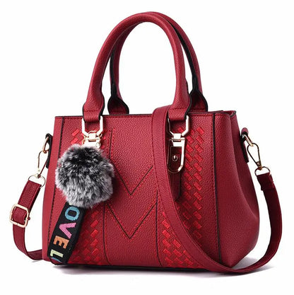 “Embroidered leather handbag for women with hairball detail, stylish and versatile.”