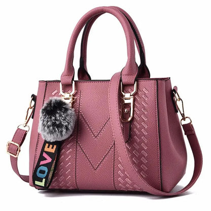 “Embroidered leather handbag for women with hairball detail, stylish and versatile.”