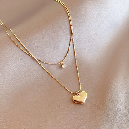 “XIYANIKE 316L Stainless Steel Double Layer Heart Pendant Necklace - Trendy Choker for Women.”