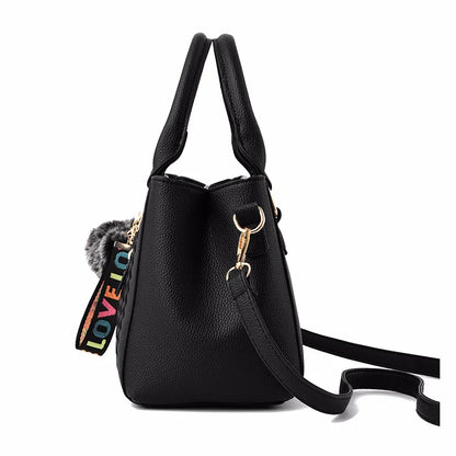 “Embroidered leather handbag for women with hairball detail, stylish and versatile.”
