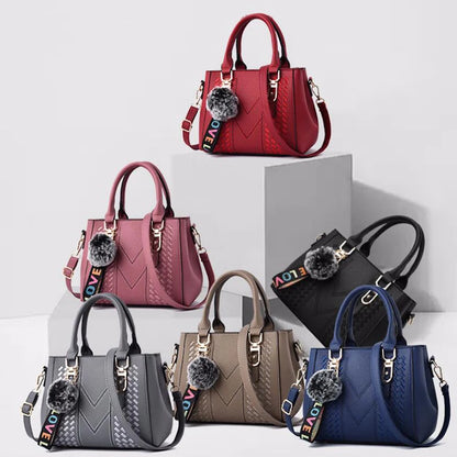 “Embroidered leather handbag for women with hairball detail, stylish and versatile.”