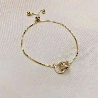 “Trendy Gold-Color Interlocked Circle Bangle, Unisex, Stylish Party Bracelet Accessory.”