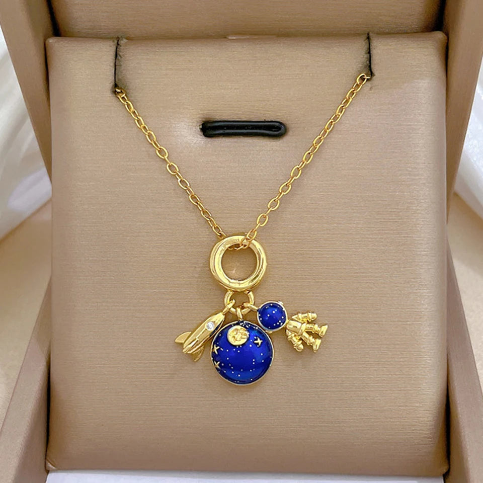 “Luxury gold titanium steel necklace with planet, moon, astronaut pendants.”