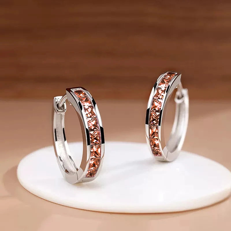 “Classic hoop earrings with princess-cut CZ, elegant and versatile women’s accessories.”
