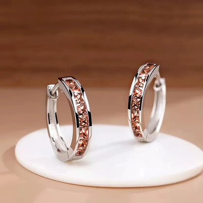 “Classic hoop earrings with princess-cut CZ, elegant and versatile women’s accessories.”