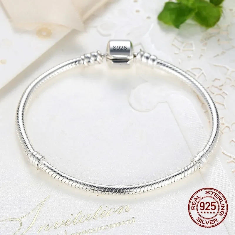 “Luxury Handmade 925 Sterling Silver Charm Bracelet - Smooth Snake Bone Design.”