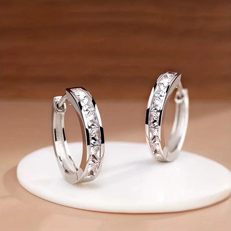 “Classic hoop earrings with princess-cut CZ, elegant and versatile women’s accessories.”