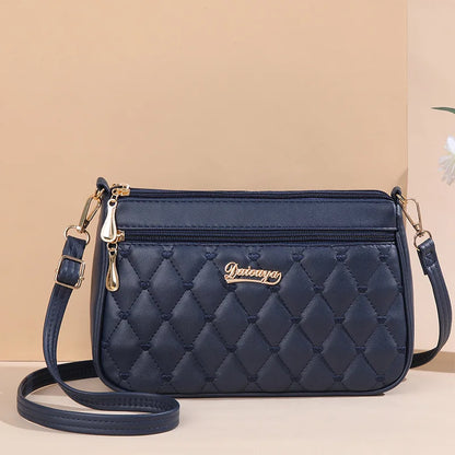 “Embroidered leather handbag for women with hairball detail, stylish and versatile.”