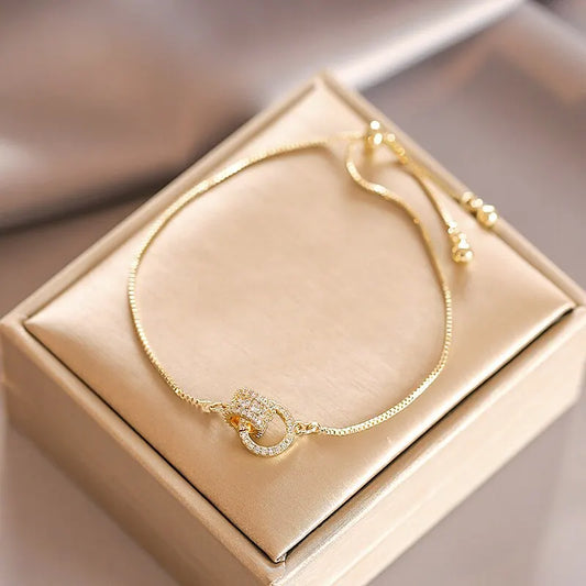 “Trendy Interlocked Gold-Color Circle Bangle for Women, Exquisite Party Jewelry.”