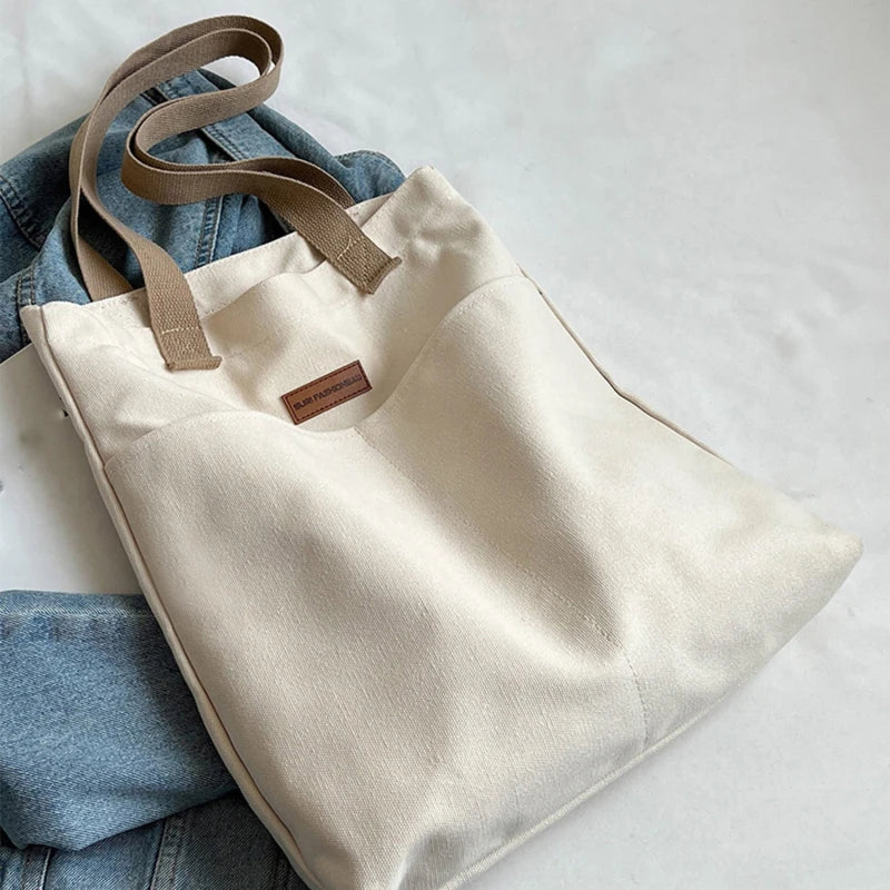 “Women’s solid color canvas tote bag, large capacity, casual, reusable, beach shopping.”