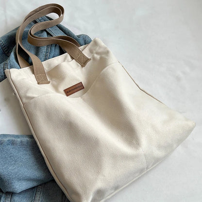 “Women’s solid color canvas tote bag, large capacity, casual, reusable, beach shopping.”