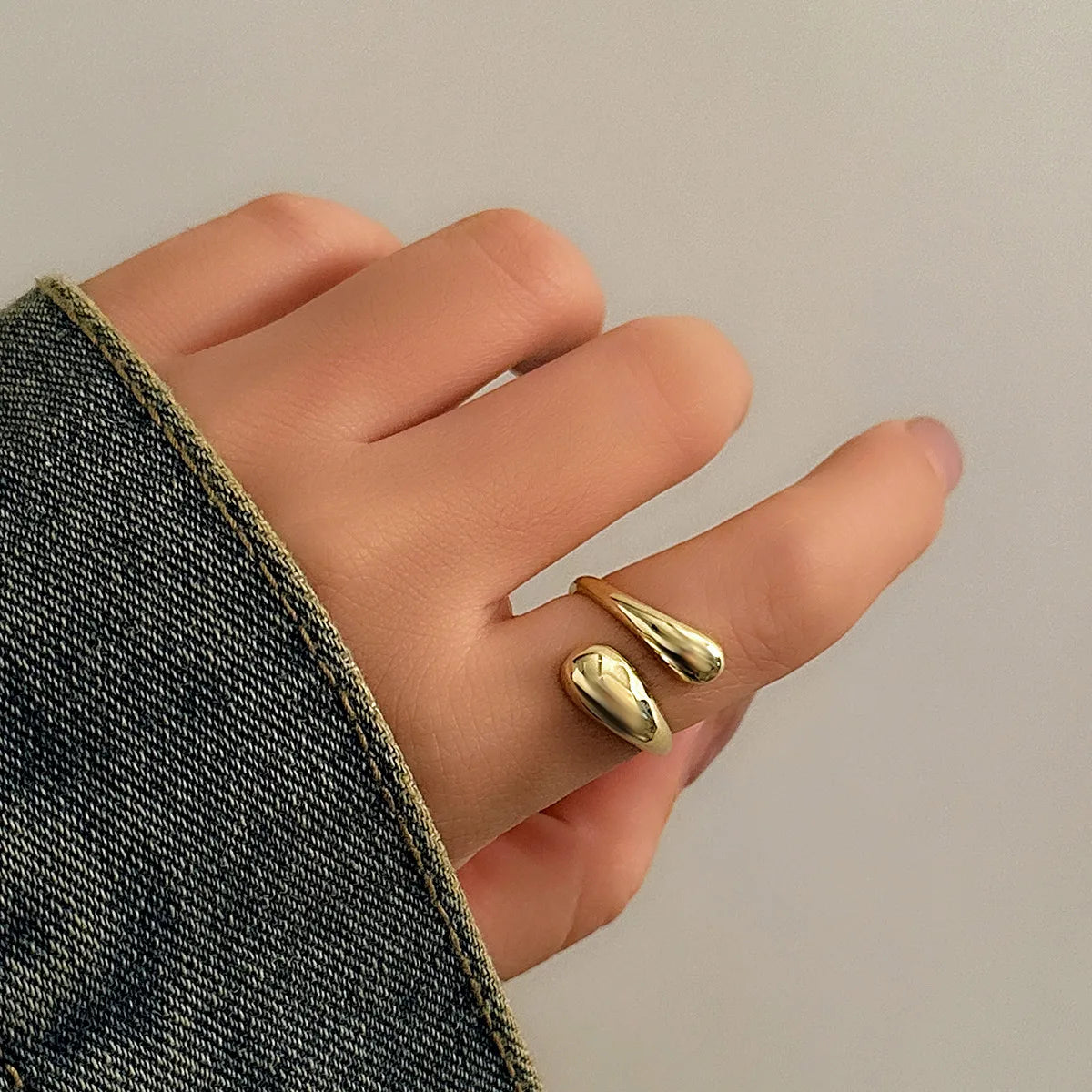 “Ingemark Creative Water Drop Metal Bangle - Gold Geometric Twisted Bracelet for Women.”