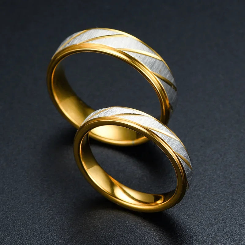 “Gold wave-pattern couple rings, stainless steel, perfect for weddings or promises.”