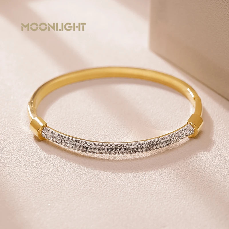 “Trendy titanium steel cuff bracelet with cubic zirconia, classic circular design.”