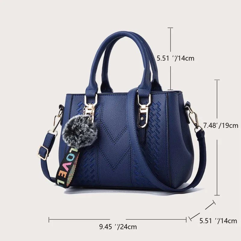 “Embroidered leather handbag for women with hairball detail, stylish and versatile.”