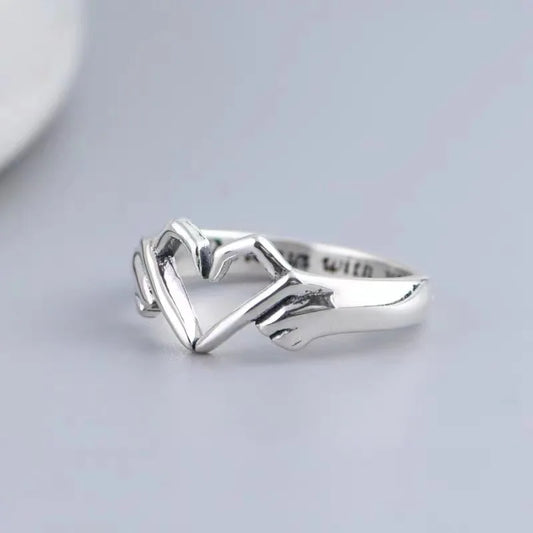 “Romantic Heart Hand Hug Ring - Adjustable Couple Ring for Wedding & Dating.”
