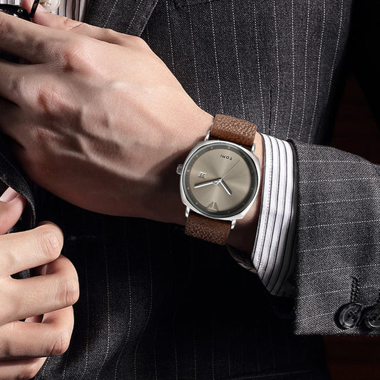 “Minimalist men’s sports watch with calendar, leather strap, casual quartz movement.”