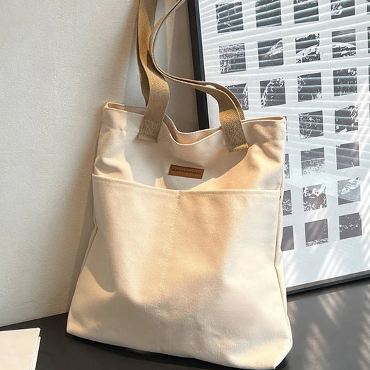 “Women’s solid color canvas tote bag, large capacity, casual, reusable, beach shopping.”