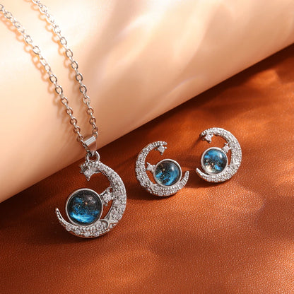 “Luxury gold titanium steel necklace with planet, moon, astronaut pendants.”