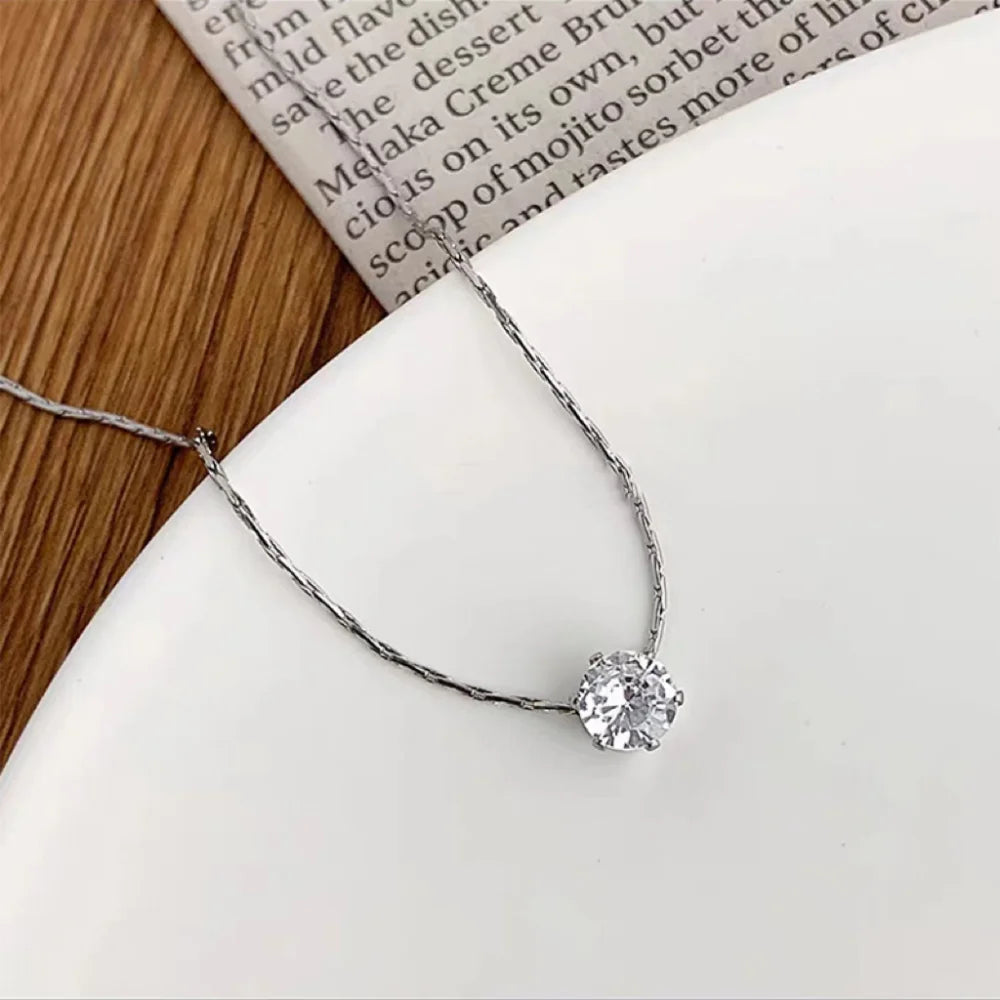 “Stainless Steel Gold Plated Zircon Necklace - Dainty Minimalist Clear CZ Charm for Women.”
