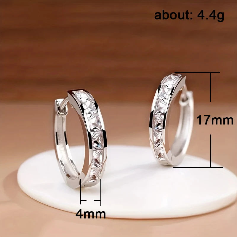 “Classic hoop earrings with princess-cut CZ, elegant and versatile women’s accessories.”
