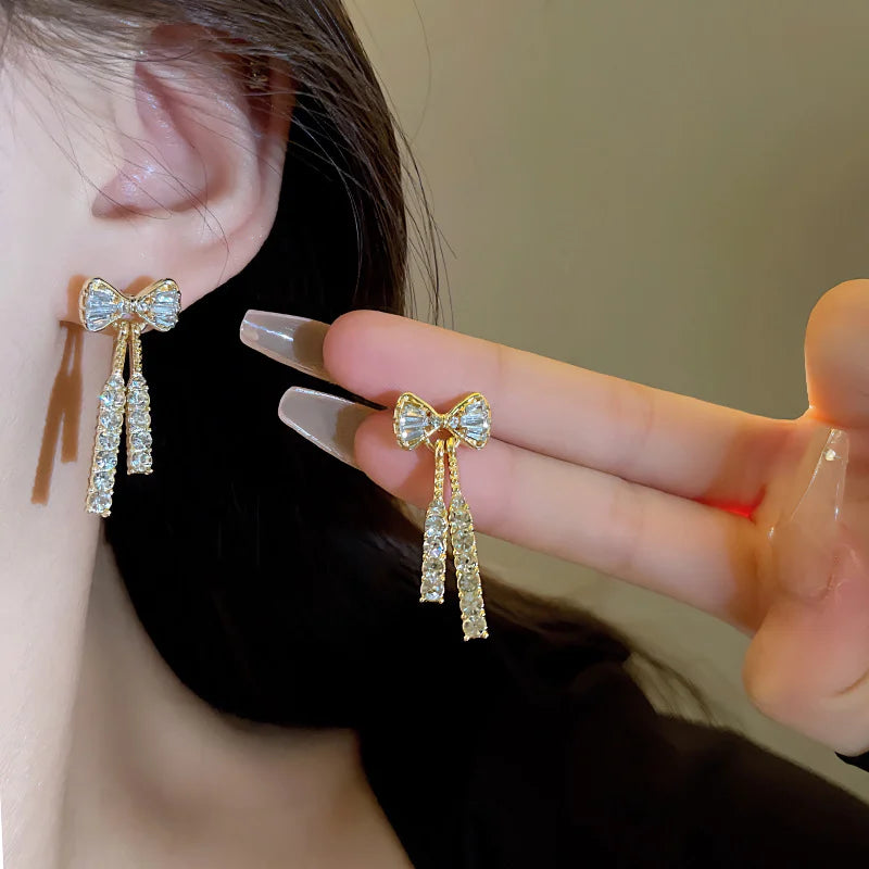 “Gold Bow Stud Earrings for Women - Dainty Rhinestone Jewelry.”