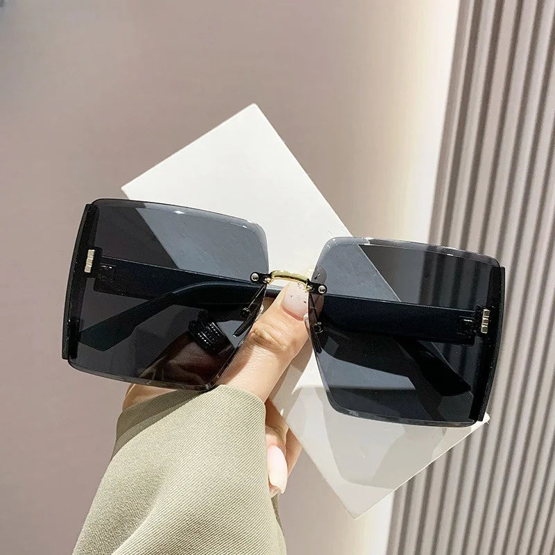 “Fashion rimless women’s sunglasses, gradient lenses, retro UV400 beach style.”